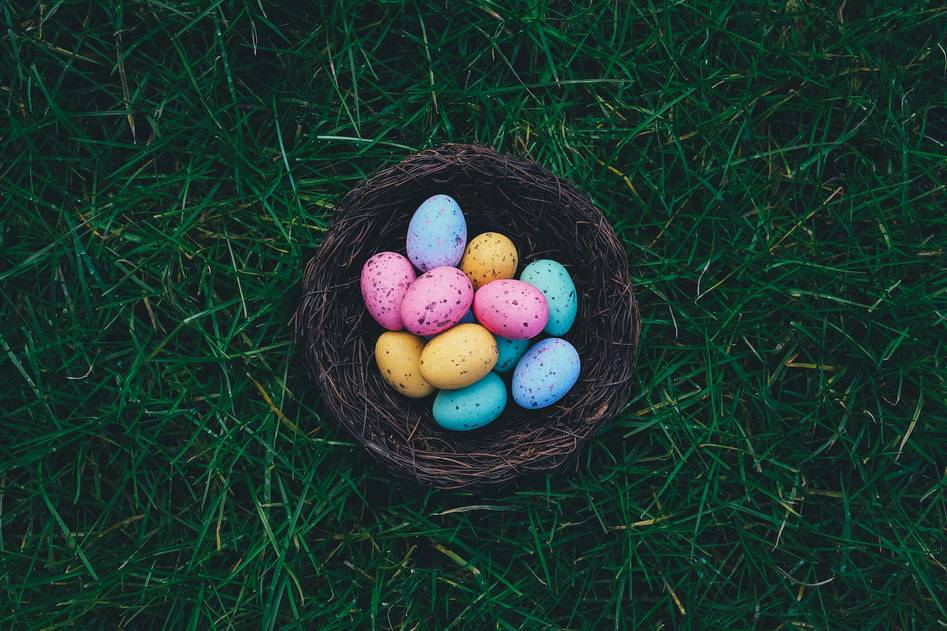 Cozy spring table setting with hand-painted eggs, linen napkins, and fresh tulips