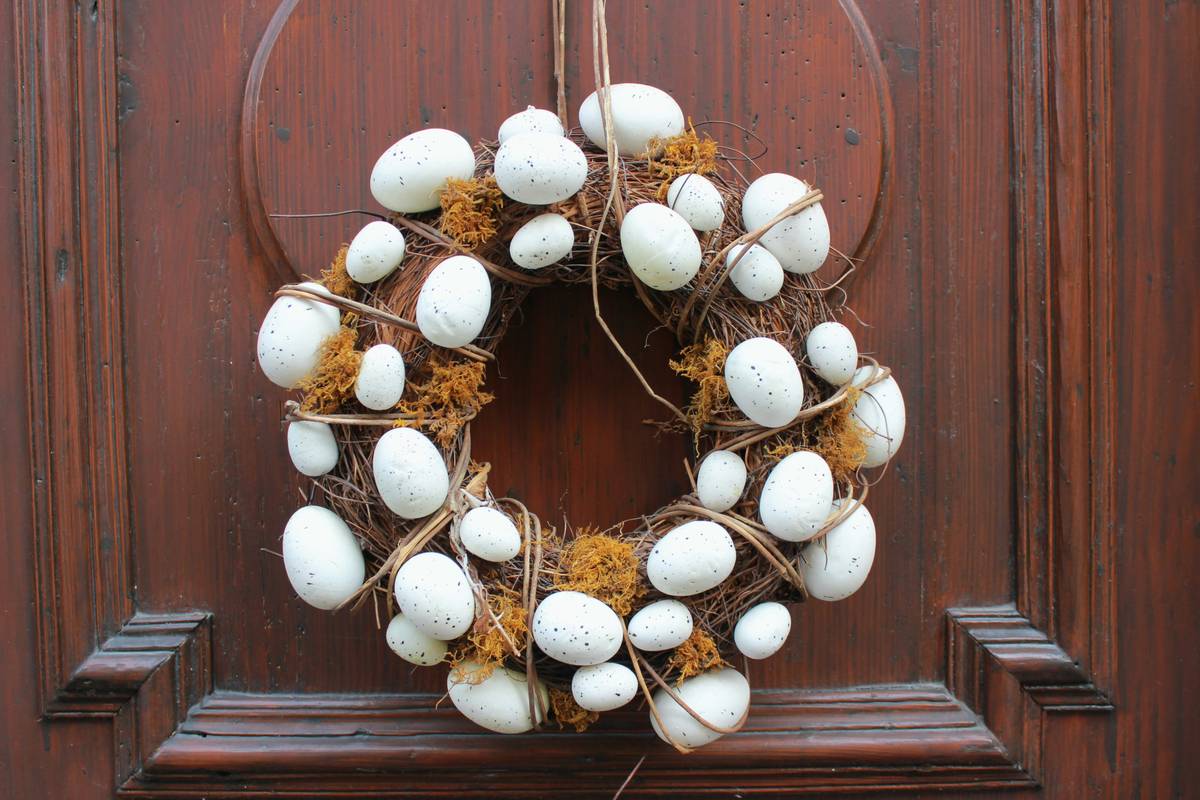 Special occasion easter decoration home good featuring pastel-colored eggs, woven baskets, and soft linen runners on a rustic wooden table