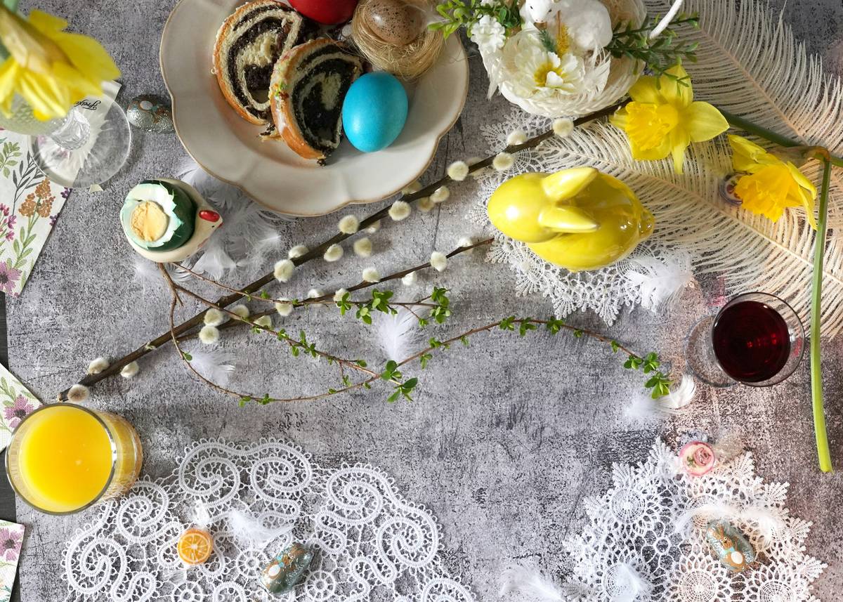 Pastel-colored easter paper plates arranged on a rustic wooden table with bunnies and eggs